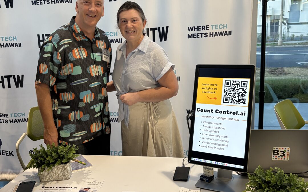 Picture of Olga & Brian Douglas at their B3 Software booth, beta testing the inventory app Count Control