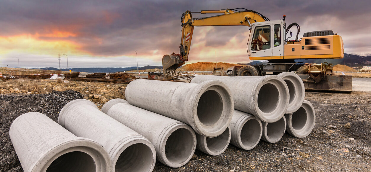 Pipes construction inventory on the construction site with rig in the background