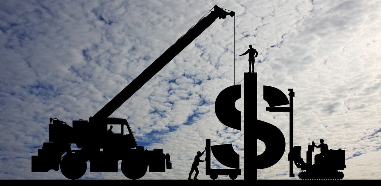 Image of a construction crane listing a part of a giant dollar sign.