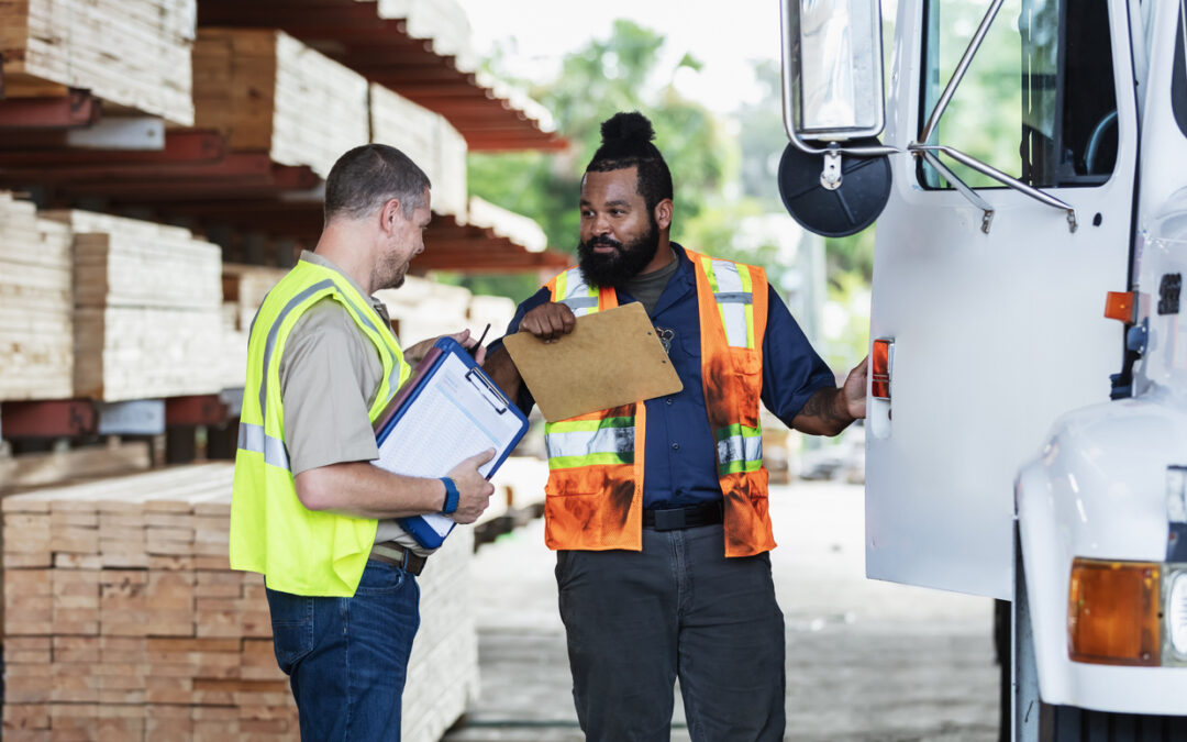 Two men in construction clothes outside of a truck Managing an Inventory delivery for a construction project