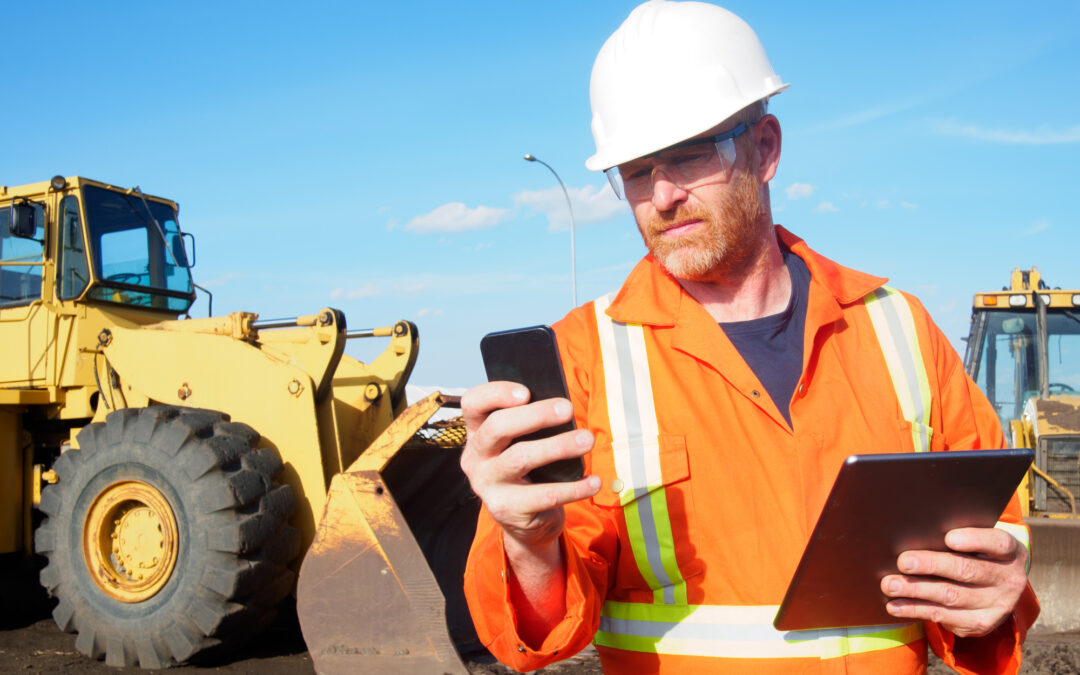 construction engineer using a tablet and smart phone to look for solutions for managing construction inefficiencies